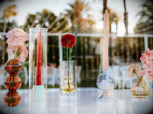 Two taper centerpieces with a red carnation.