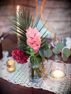 A fern and pale pink floral arrangement.