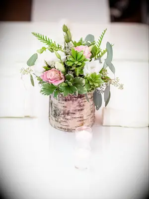 A lovely floral centerpiece with greenery and pink flowers.