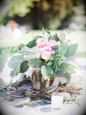 A lovely floral arrangement of pale pink roses and greenery.