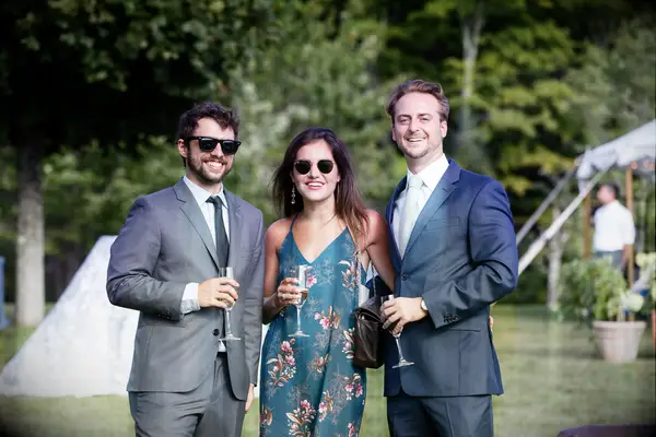 guests holding wine glasses at outdoor engagement party