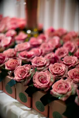 engagement party favor boxes with a pink rose on top of each box