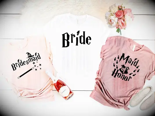 HP themed t-shirts in blush colors and white for the bride with lightning bolt and wand graphics