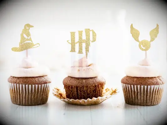 Gold glittery cupcake toppers of sorting hat, HP and snitch