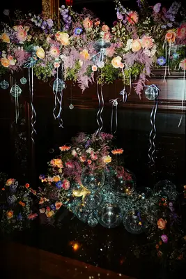 Fireplace installation with disco ball and floral decor