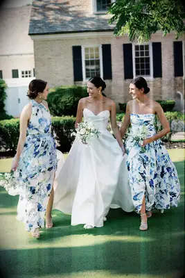 Bridesmaids and Bride walking in a garden