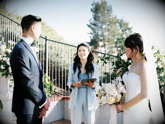 Couple exchanging vows at outdoor ceremony