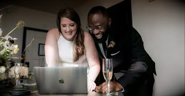 how to make a wedding website; couple using best wedding website