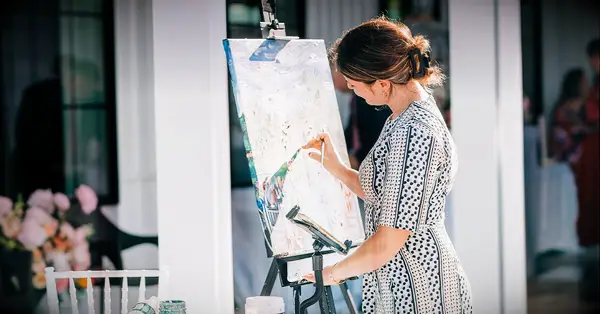 couple hired wedding painter and other wedding vendors while planning wedding