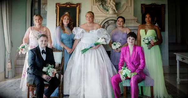 bride celebrating wedding plans and posing with bridesmaids and wedding party 