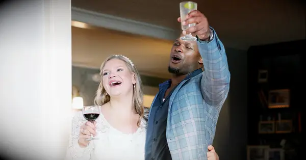 couple toasting after planning an pre-wedding engagement party