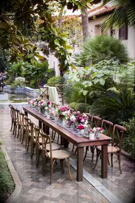 outdoor wedding reception with small wooden table