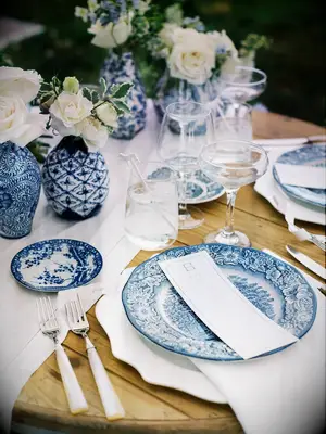 Chinoiserie charger plates, bowls and vases on secret-garden-themed table