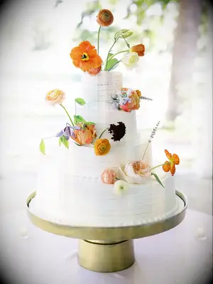 Four-Tier, White Wedding Cake With Fresh-and-Colorful Spring Flowers
