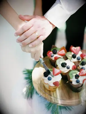 couple cutting fresh berry muffins