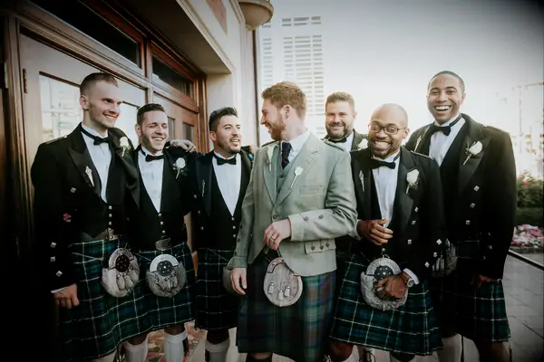 Groom and groomsmen wearing traditional kilts