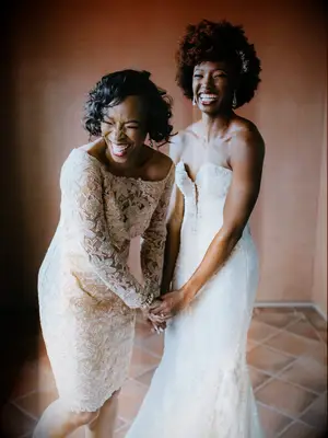 bride laughing with mother of the bride