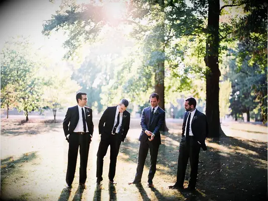 groom and groomsmen standing together casually