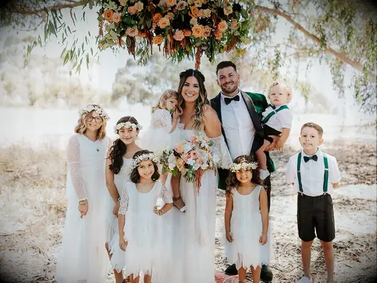 bride and groom with young wedding party members