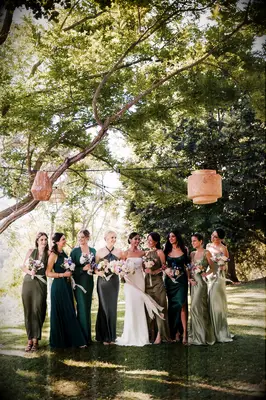 Bride and bridesmaids under tree