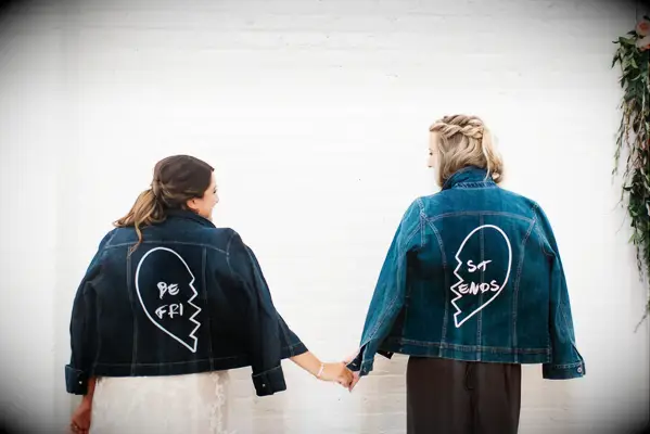 Bride and bridesmaid in best friends denim jackets