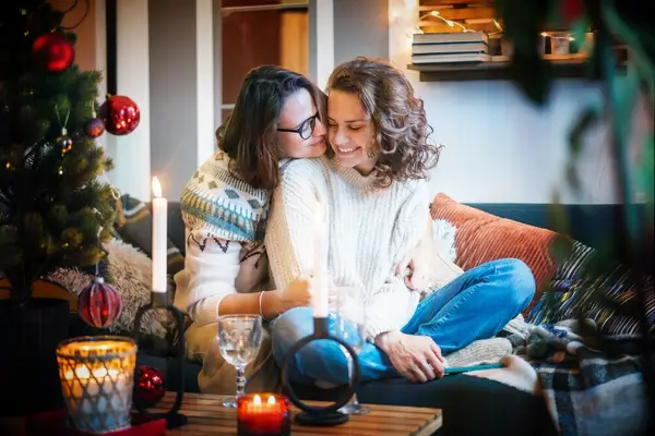 Couple sitting on the couch together on Christmas day