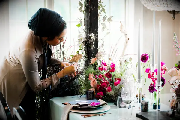 Woman styling tables on wedding day