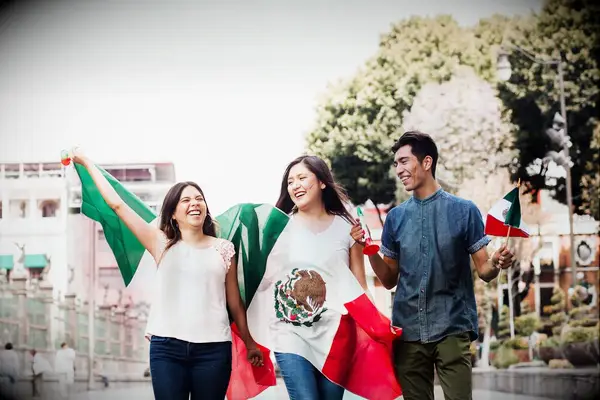 Young people holding Mexican Flag