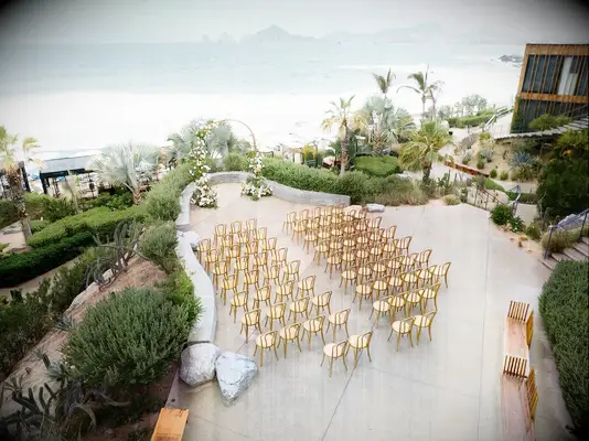 Wedding ceremony hosted on hotel balcony overlooking ocean at The Cape Hotel in Cabo San Lucas, Mexico