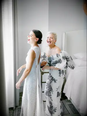 Mother of the bride and daughter laughing 