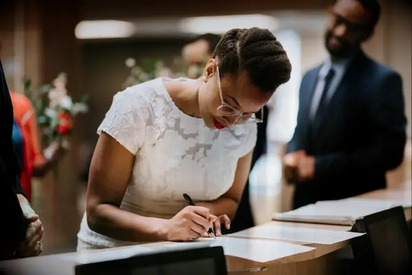 Bride signing marriage certificate
