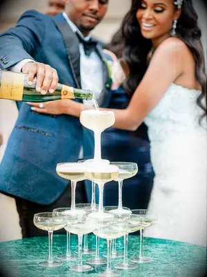 Small champagne coupe tower at wedding reception.