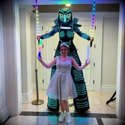 Guest standing in front of party robot