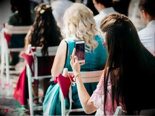 Wedding guest taking photo at wedding ceremony