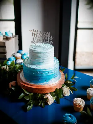 Small two-tier blue ombré beach-themed wedding cake