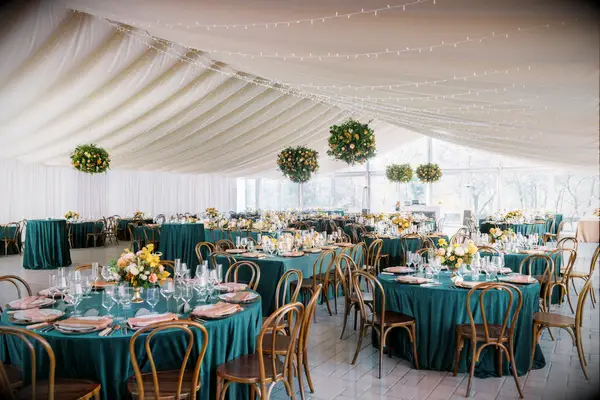 Tented wedding reception space with jewel-toned decor