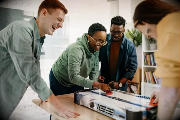 Two couples playing foosball together