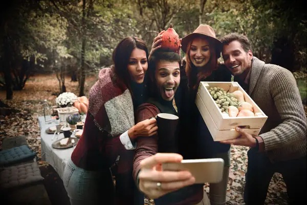 Two couples picking apples