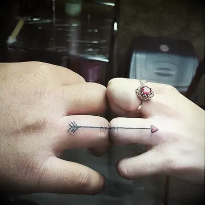 Connected arrow tattoo
