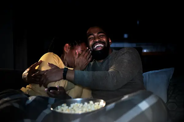 Couple watching halloween movie at home