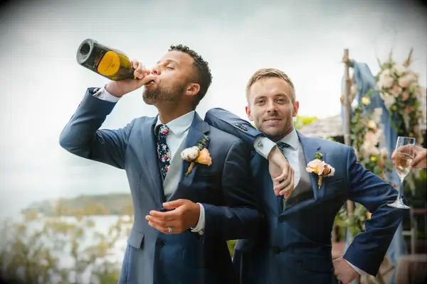 Couple Poses: Couple drink champagne while posing for camera. 