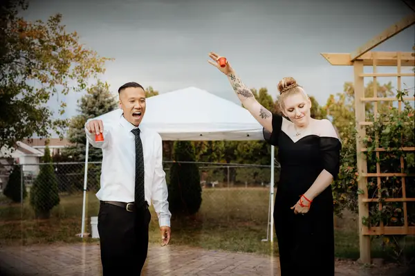 Cute Couple Poses: Couple raises their glasses in a toast. 