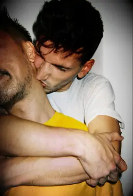 Man kissing partner on neck 