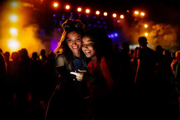 A lesbian couple enjoys a concert together