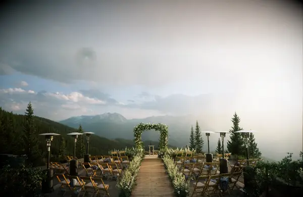Venue: The Little Nell wedding deck on a misty day with clouds and sun beaming through