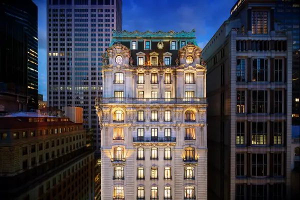 St. Regis Hotel exterior at dusk all lit up in nyc