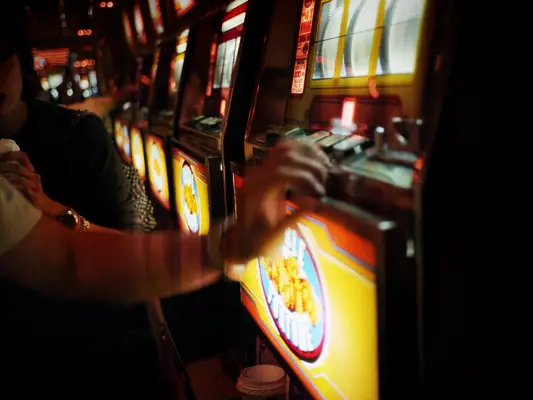 Couple playing slot machine in casino