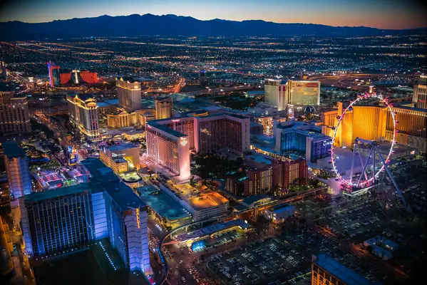 view of vegas the strip and the high roller ferris wheel at dusk in sin city