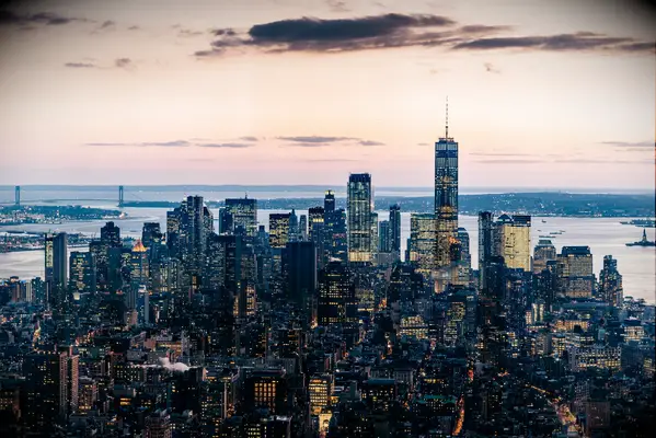 new york city skyline lower manhattan at sunset sublime lights on buildings and a pink sky with clouds