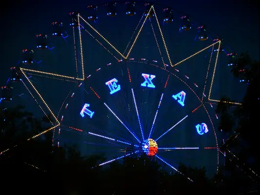 Ferris wheel lit up with letters spelling Texas